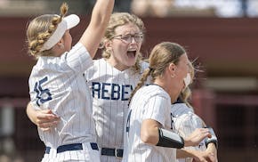 Jubilant teammates gather with Champlin Park pitcher Marissa Rothenberger, center, as they celebrate their Class 4A softball state championship Friday