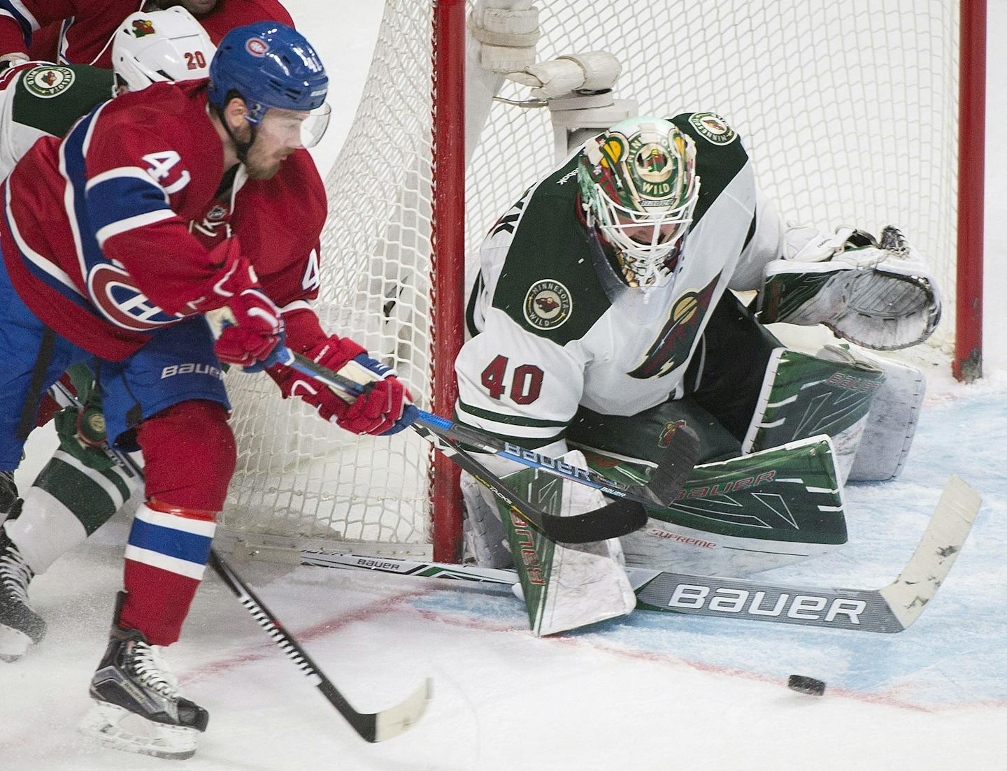 Montreal Canadiens' Paul Byron (41) moves against Minnesota Wild's goaltender Devan Dubnyk as during third-period NHL hockey game action in Montreal, Thursday, Dec. 22, 2016. (Graham Hughes/The Canadian Press via AP)