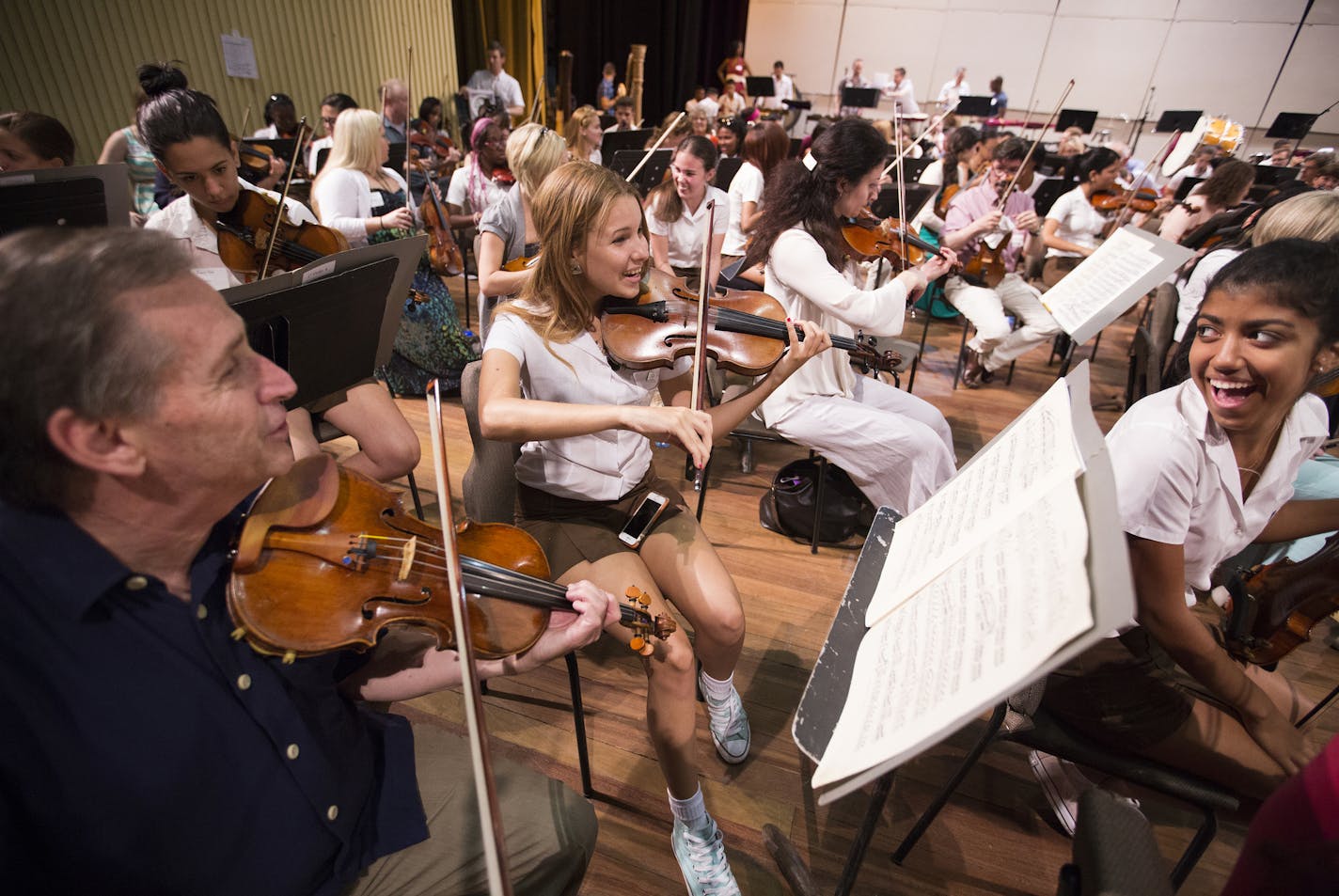 Violin players Christa Morera, from right, and Danielle Gonzalez of the Orquesta Sinfonica Juvenil del Conservatorio takes part in a side-by-side rehearsal with Roger Frisch of the Minnesota Orchestra at Teatro Nacional in Havana, Cuba on Friday, May 15, 2015. ] LEILA NAVIDI leila.navidi@startribune.com /