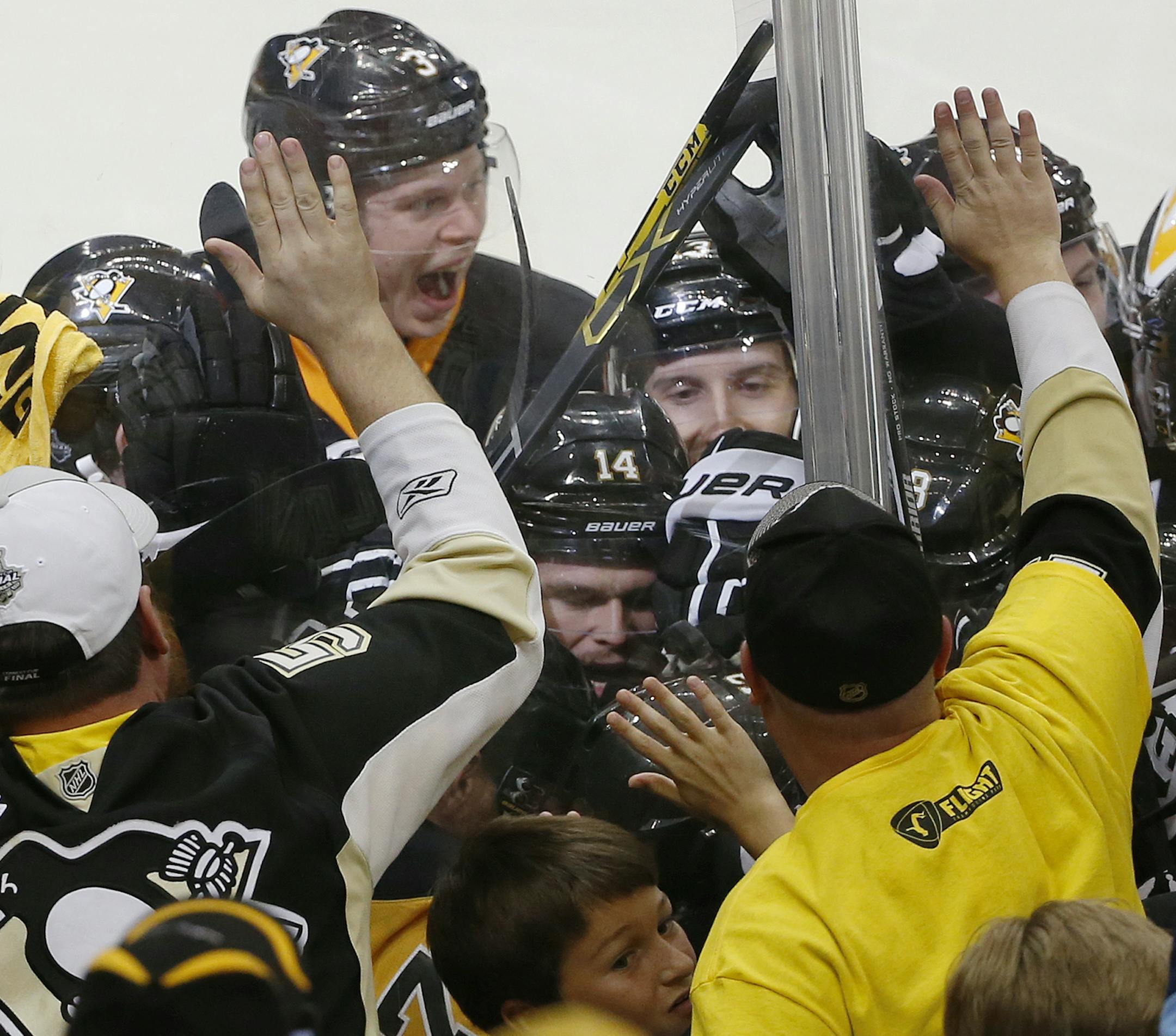 Pittsburgh Penguins' Conor Sheary is mobbed by teammates after his goal against the San Jose Sharks during overtime in Game 2 of the NHL hockey Stanley Cup Finals on Wednesday, June 1, 2016, in Pittsburgh. The Penguins won 2-1 to take a 2-0 series lead. (AP Photo/Gene J. Puskar)