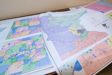 Julius Menchikov was busy printing and mounting huge copies of Minnesota’s new redistricting map on Tuesday in St. Paul.