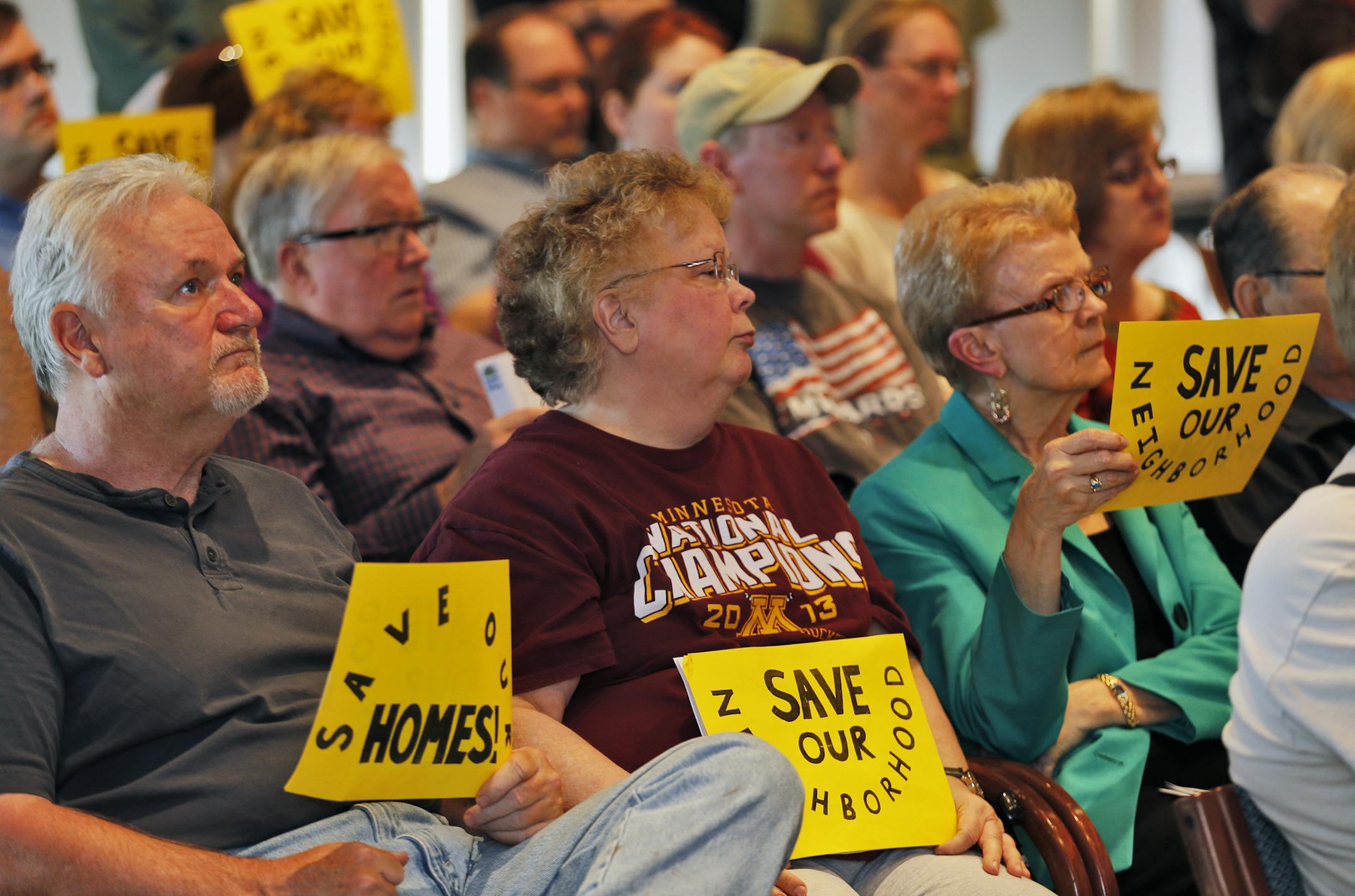 Homewowners displayed signs at the meeting.
