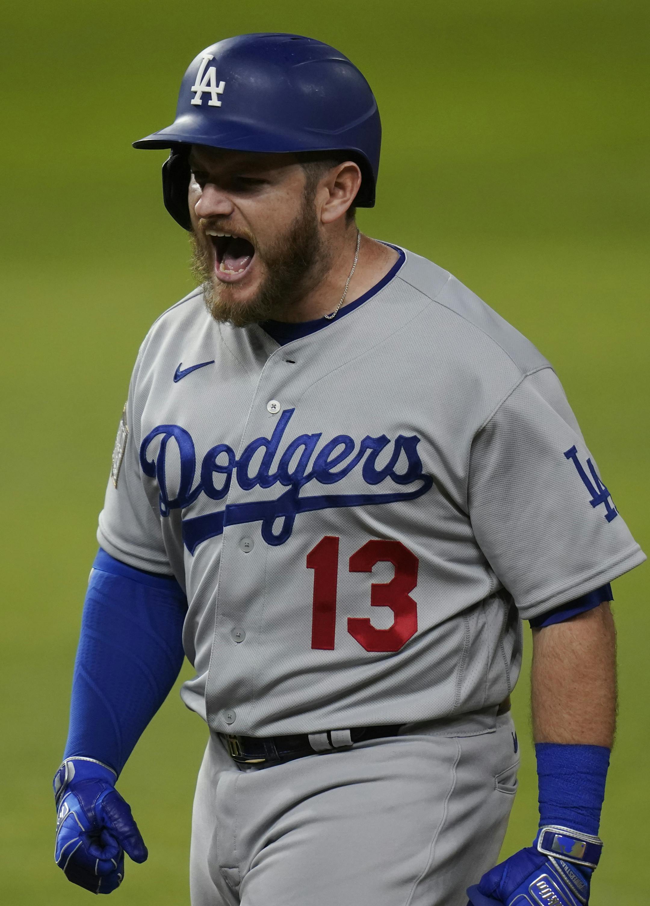 Los Angeles Dodgers' Max Muncy celebrates after two-RBI single against the Tampa Bay Rays during the third inning in Game 3 of the baseball World Series Friday, Oct. 23, 2020, in Arlington, Texas. (AP Photo/Eric Gay)