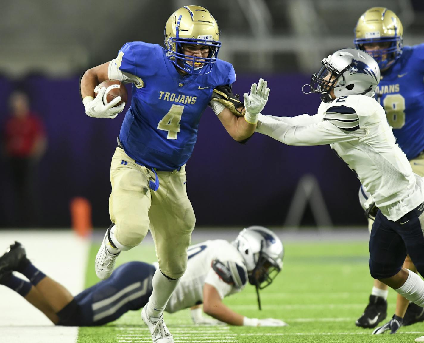 Wayzata running back Christian Vasser (4) broke a tackle before being pushed out of bounds by Champlin Park defensive back Josh Strong (2) in the fourth quarter for a first down. ] Aaron Lavinsky &#x2022; aaron.lavinsky@startribune.com Wayzata played Champlin Park in the Class 6A State Tournament Championship game on Friday, Nov. 29, 2019 at US Bank Stadium in Minneapolis, Minn.