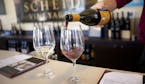 Chris Calley pours wine at Scheid Vineyards tasting room in Carmel-by-the Sea, Calif. One of the easiest ways to go wine tasting in this region is on 