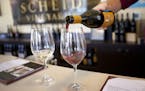 Chris Calley pours wine at Scheid Vineyards tasting room in Carmel-by-the Sea, Calif. One of the easiest ways to go wine tasting in this region is on 
