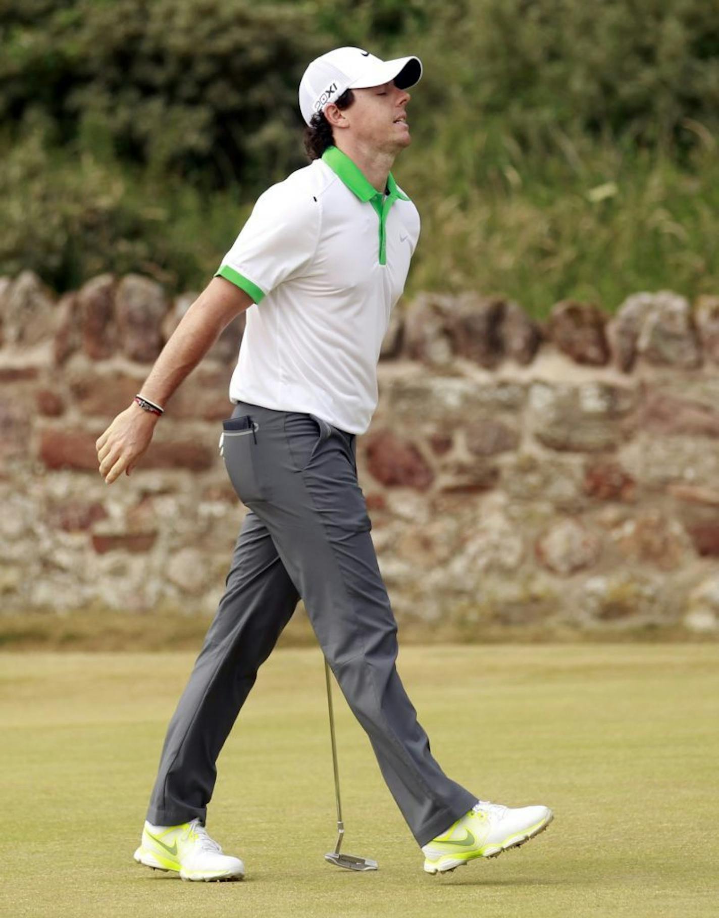 Rory McIlroy of Northern Ireland reacts after missing a putt on the second green during the first round of the British Open Golf Championship at Muirfield, Scotland, Thursday July 18, 2013.