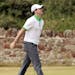 Rory McIlroy of Northern Ireland reacts after missing a putt on the second green during the first round of the British Open Golf Championship at Muirf