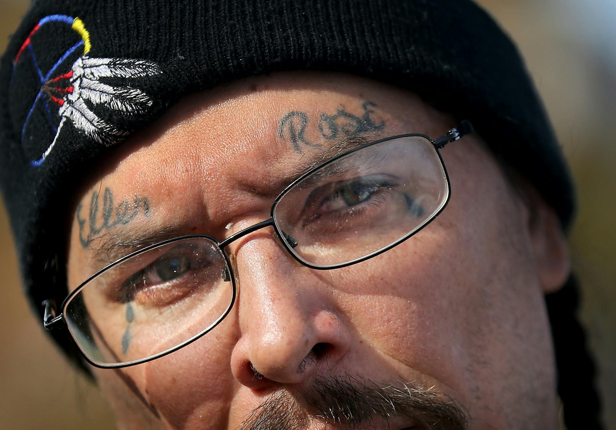 This week, after months of living at a crowded homeless camp, Mike and Ellen Eagletail and their three children finally moved into a place of their own. They are among a small but growing number of people at a south Minneapolis homeless camp who are starting to find housing. Mike Eagletail says sometimes people can be quick to judge him based on appearance. Out of love, respect and devotion to his wife Ellen Rose he has her first and middle name tattooed on his forehead. Three tear drops are tat