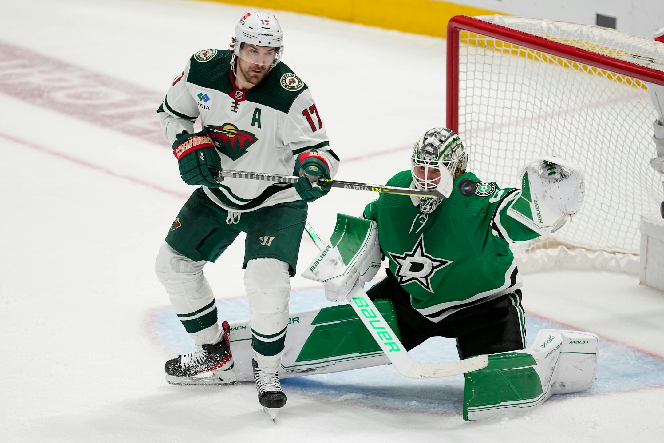 Minnesota Wild left wing Marcus Foligno (17) pressures the net as Dallas Stars goaltender Jake Oettinger (29) defends against a shot in the third period.