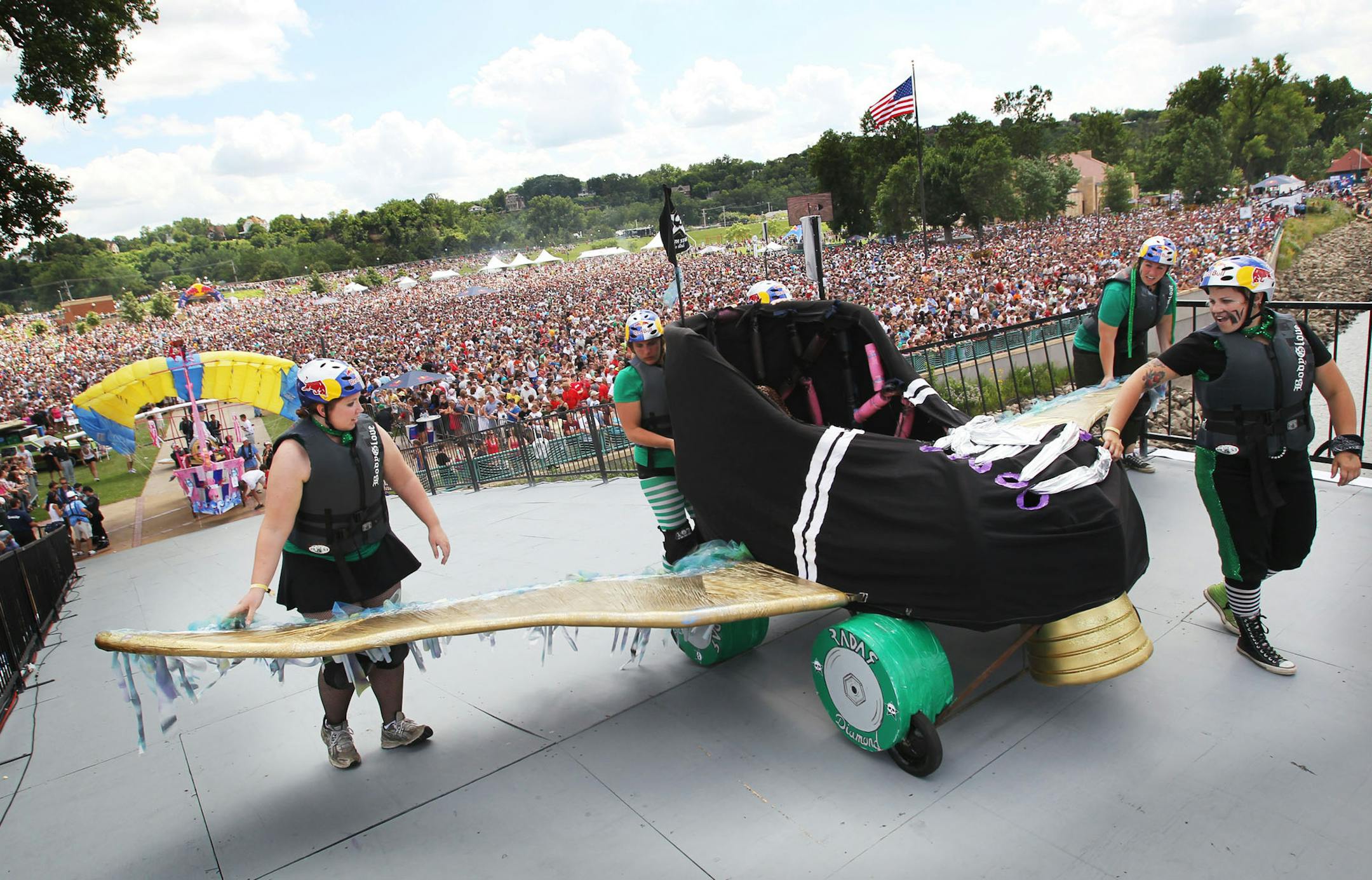 DAVID JOLES ¥ djoles@startribune.com - St. Paul MN - July 24, 2010- Red Bull Flugtag - an amateur flying competition - came to Harriet Island Park in St. Paul, with 37 teams with homemade, man-powered flying machines launched their crafts off a 30-foot platform and attempt to fly or crash in the Mississippi River. In this photo:] A huge crowd watches at the North Star Roller Girls roll onto the platform.