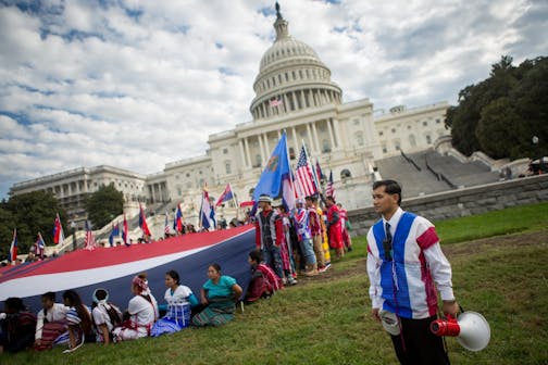 Members of the Karen ethnic group hold a giant Karen flag as they rally to bring attention to the human rights violations towards religious and ethnic minorities in the Burma region, in front of the U.S. Capitol building on Capitol Hill in Washington, D.C., November 6, 2017. As resettlement of Karen refugees to the United States winds down, advocacy efforts have increased in support of more than 120,000 Karen who remain in Thai refugee camps.