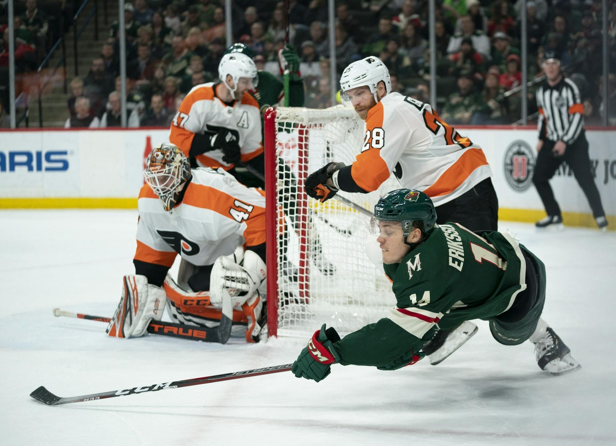 As he fell to the ice, Minnesota Wild center Joel Eriksson Ek (14) managed to feed passed Wild center Luke Kunin for an assist on his second first period goal.