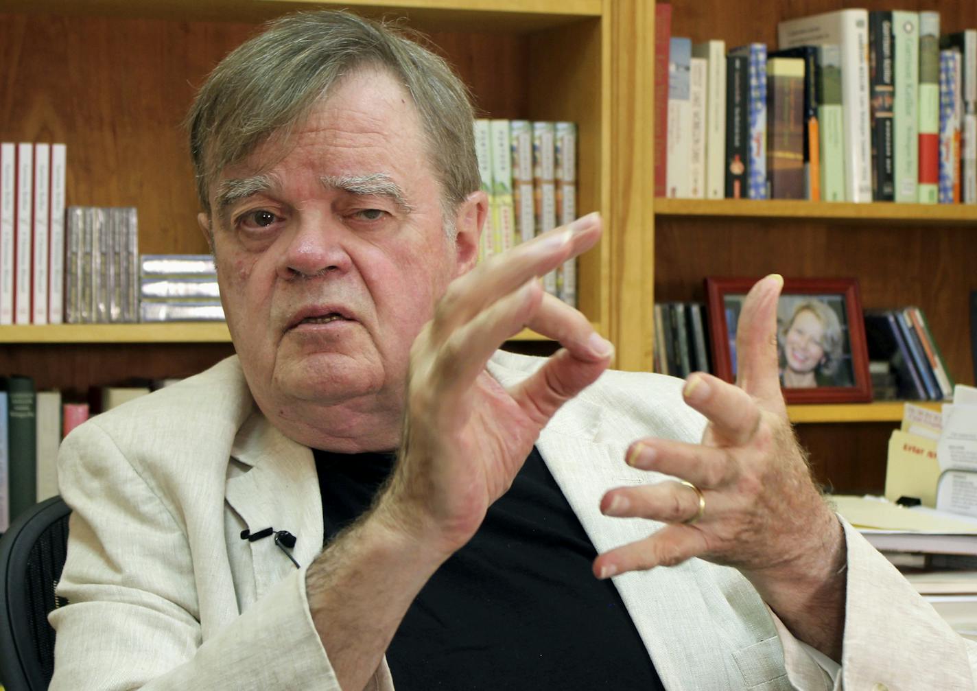 FILE - In this July 26, 2017, file photo, Garrison Keillor, creator and former host of, "A Prairie Home Companion," talks at his St. Paul, Minn., office. Keillor says he is in negotiations with Minnesota Public Radio after the radio network cut ties with him over unspecified allegations of inappropriate behavior. Keillor wrote on his Facebook page Friday, Jan. 5, 2018, that a second day of mediation was held at a law firm in downtown Minneapolis, but he provided no details. (AP Photo/Jeff Baenen