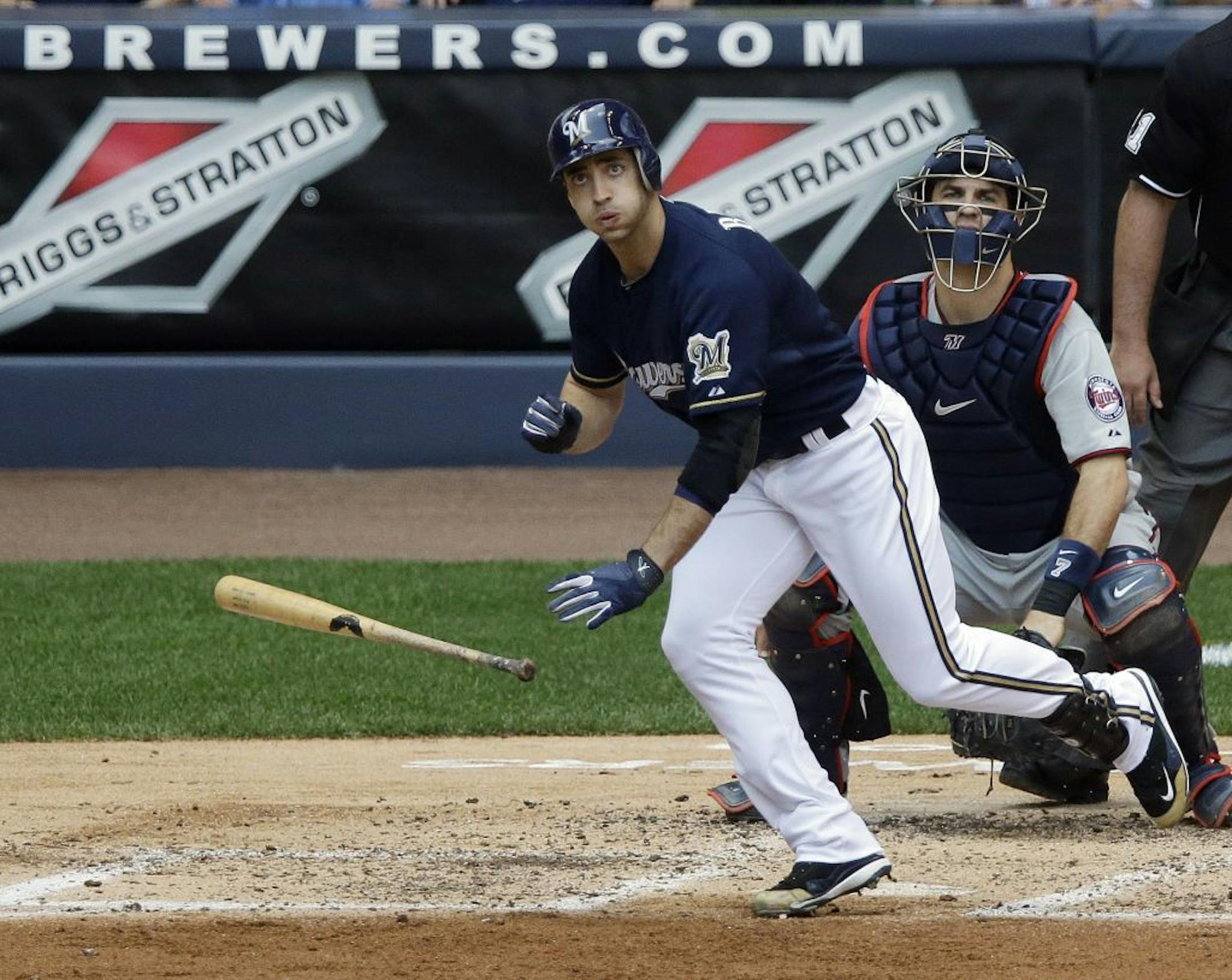 Minnesota Twins catcher Joe Mauer, right, watches as Milwaukee Brewers' Ryan Braun, left, hits a two-run-scoring double during the second inning of an interleague baseball game on Sunday, May 20, 2012, in Milwaukee.