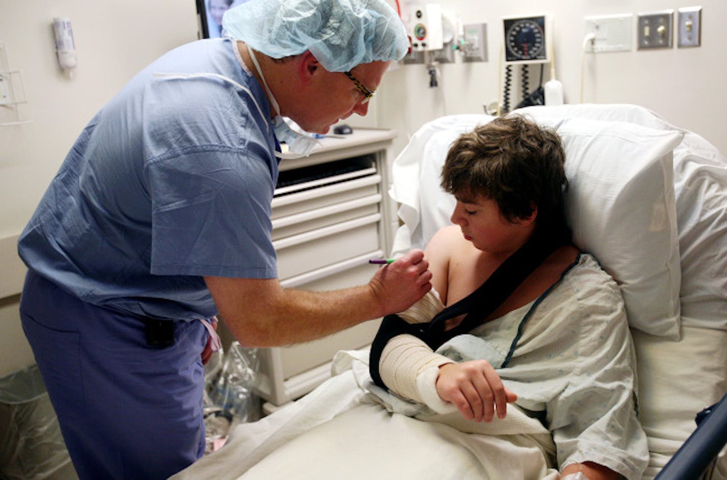 Doctor Peter Cole marked his initials on 15-year-old Ben Pelner's right arm before surgery at Regions Hospital in St. Paul Tuesday, January 6, 2009. The marking assures the surgery is done on the right area, and helps avoid mistakes during the process.