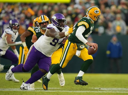 Dalvin Tomlinson, left, had the Vikings’ only sack of Aaron Rodgers on Sunday. 