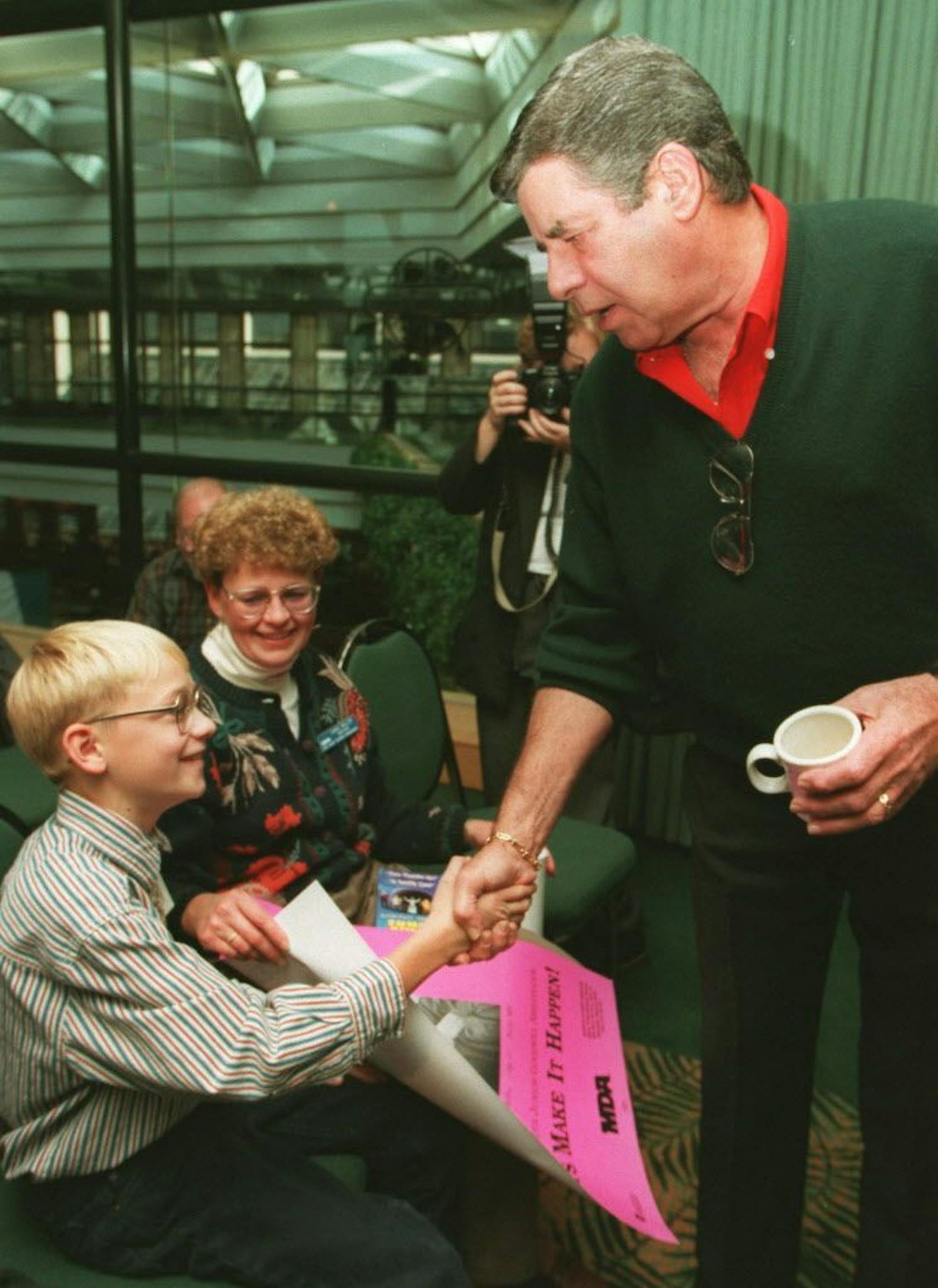 Comedian Jerry Lewis, in town in his role in Damn Yankees, which opened Oct. 17, 1995, at St. Paul's Ordway Theater, paused after his Tuesday press conference to greet Robert Miller, 11, Foley, Minn., Minnesota good will ambassador for Muscular Distrophy. Lewis signed autographed photos of himself for several youngsters who attended the session.
