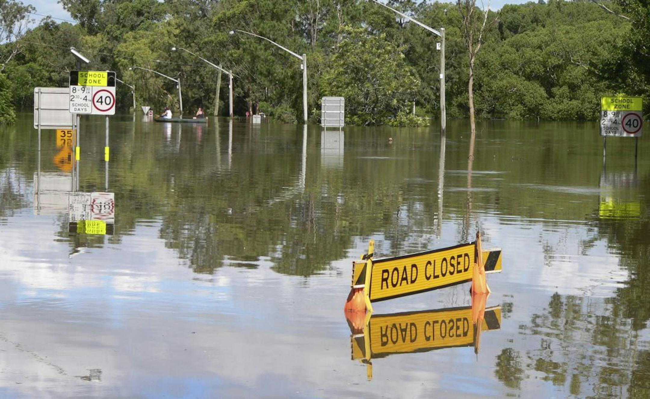 This photo supplied by NSW State Emergency Service, shows the Bruxner Highway covered with floodwaters caused by torrential rains in Lismore, northern New South Wales, Australia Tuesday, Jan. 29, 2013. Thousands of Australians huddled in shelters Tuesday as torrential rains flooded cities and towns in the northeast. With floodwaters expected to peak in most of the worst-hit areas later Tuesday, officials were rushing to move those in the highest-risk areas to safety. (AP Photo/NSW State Emergenc