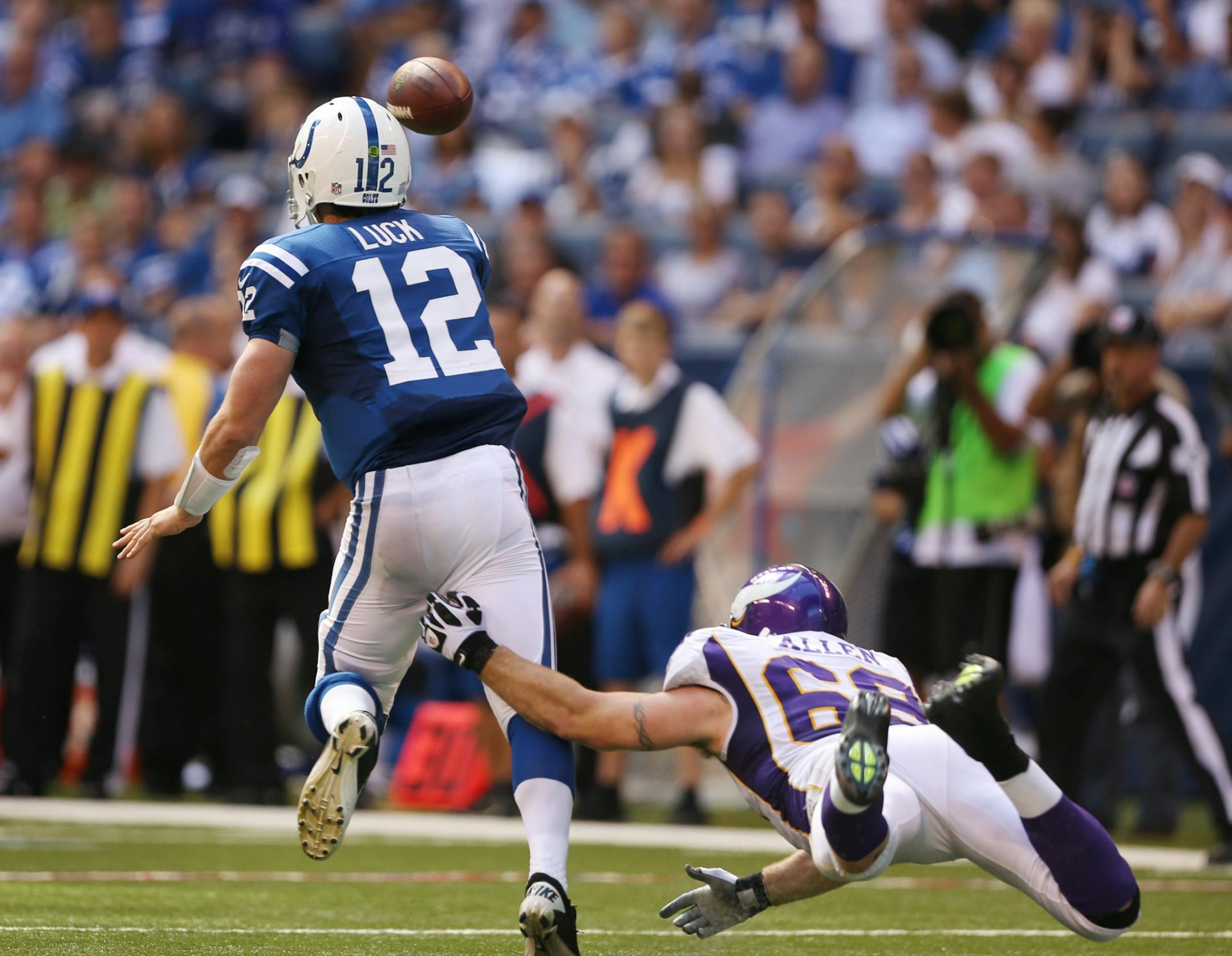 Indianapolis Colts quarterback Andrew Luck (12) avoid the sack by Minnesota Vikings defensive end Jared Allen (69)