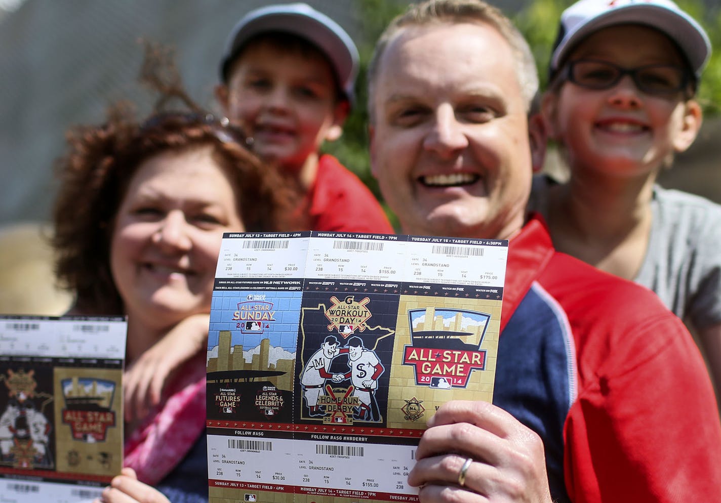 Blake Fry and his wife Michele, hold their coveted All-Star Game tickets before heading to watch the Twins take on the New York Yankees with their children Liam, 7, and Abby, 11, Friday, July 4, 2014, at Target Field.