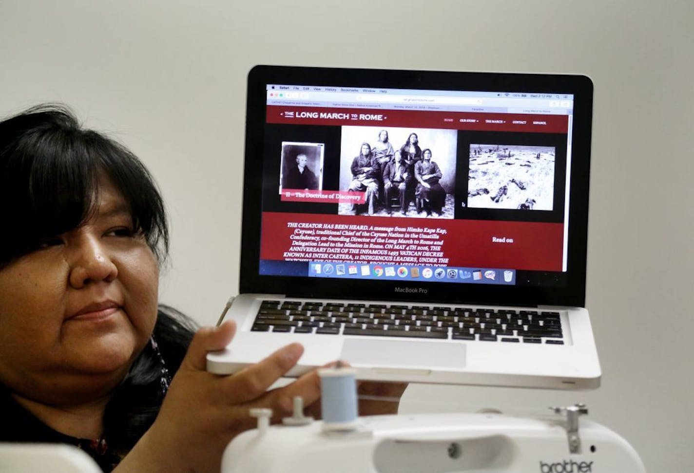 Dianna Johnson, who is of Oglala Lakota and Northern Cheyenne descent, along with her daughter Nina Berglund, 18, will travel to Rome to meet Pope Francis this spring. Here, Johnson was seen holding up a web page dedicated to a group of Native Americans who traveled to Rome in 2016 to meet with the Pope Wednesday, March 14, 2018, at the St. Paul Public Schools Indian Education center in St. Paul, MN.. "All these doors are opening for these guys," Johnson said about the trip and her daughter and