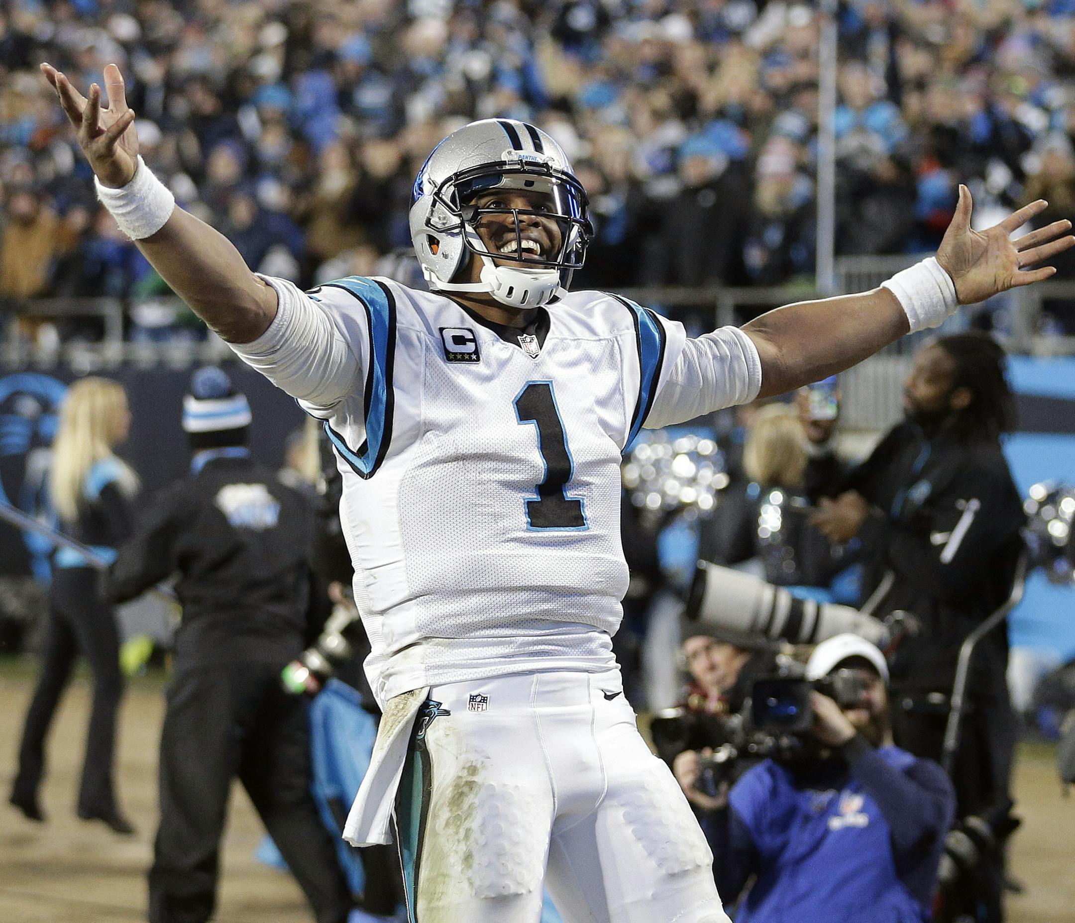 Carolina Panthers' Cam Newton celebrates a touchdown pass during the second half the NFL football NFC Championship game against the Arizona Cardinals Sunday, Jan. 24, 2016, in Charlotte, N.C. (AP Photo/Chuck Burton)