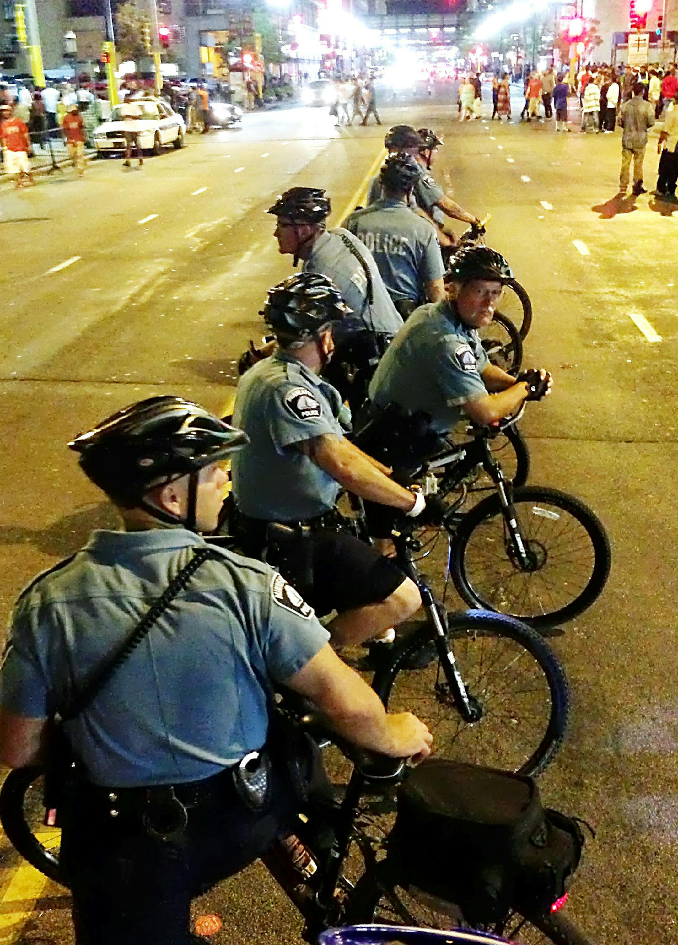 ERIC ROPER/STAR TRIBUNE. Members of the bike rapid response team line up on Hennepin Avenue at 2:11 a.m. on Friday night, watching people spill out of clubs that stop serving liquor at 2 a.m. Moments later, a fight would break out in a nearby parking lot.