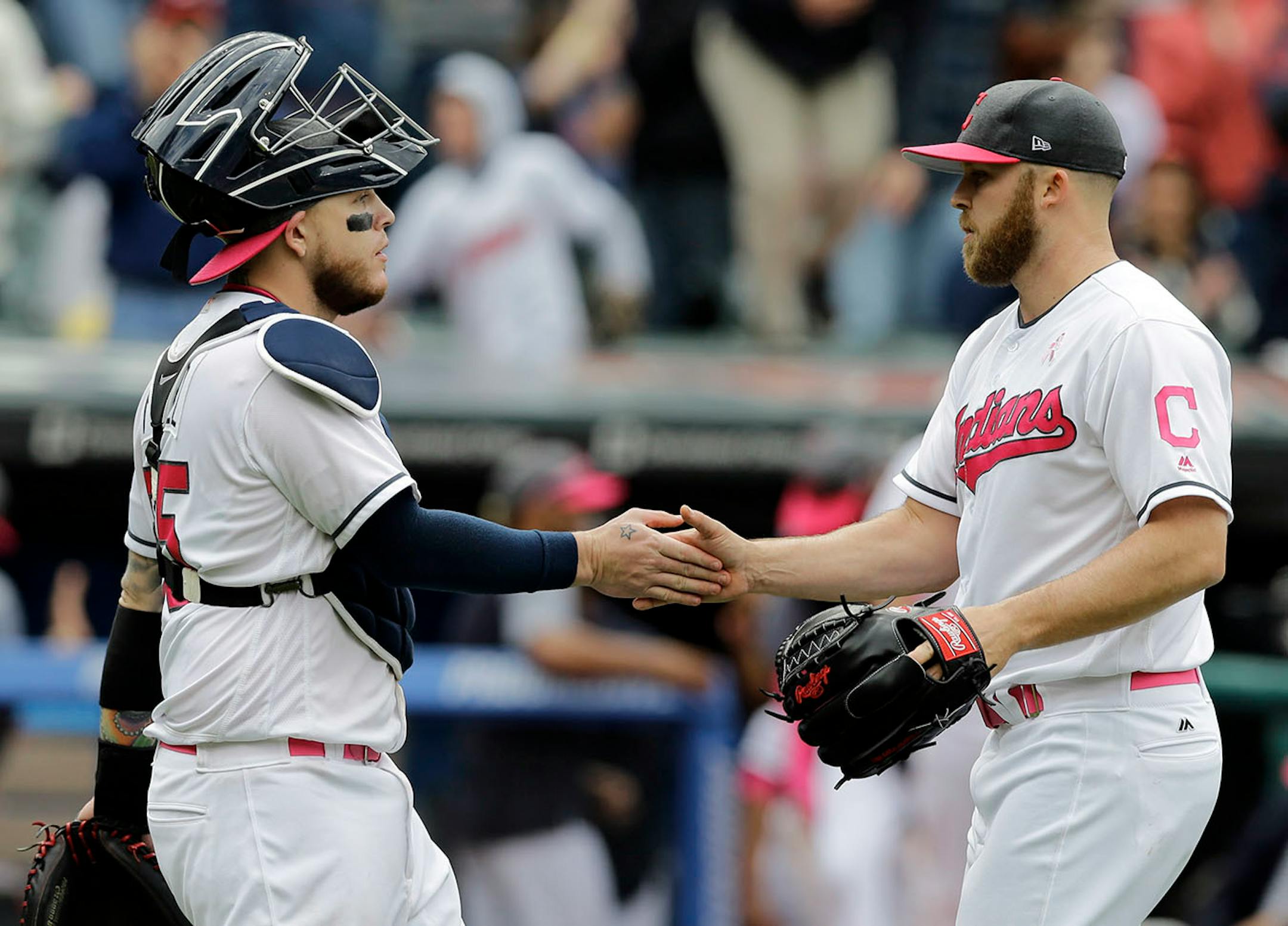 Cleveland Indians relief pitcher Cody Allen, right, is congratulated by catcher Roberto Perez after the Indians defeated the Minnesota Twins 8-3 in a baseball game, Sunday, May 14, 2017, in Cleveland.