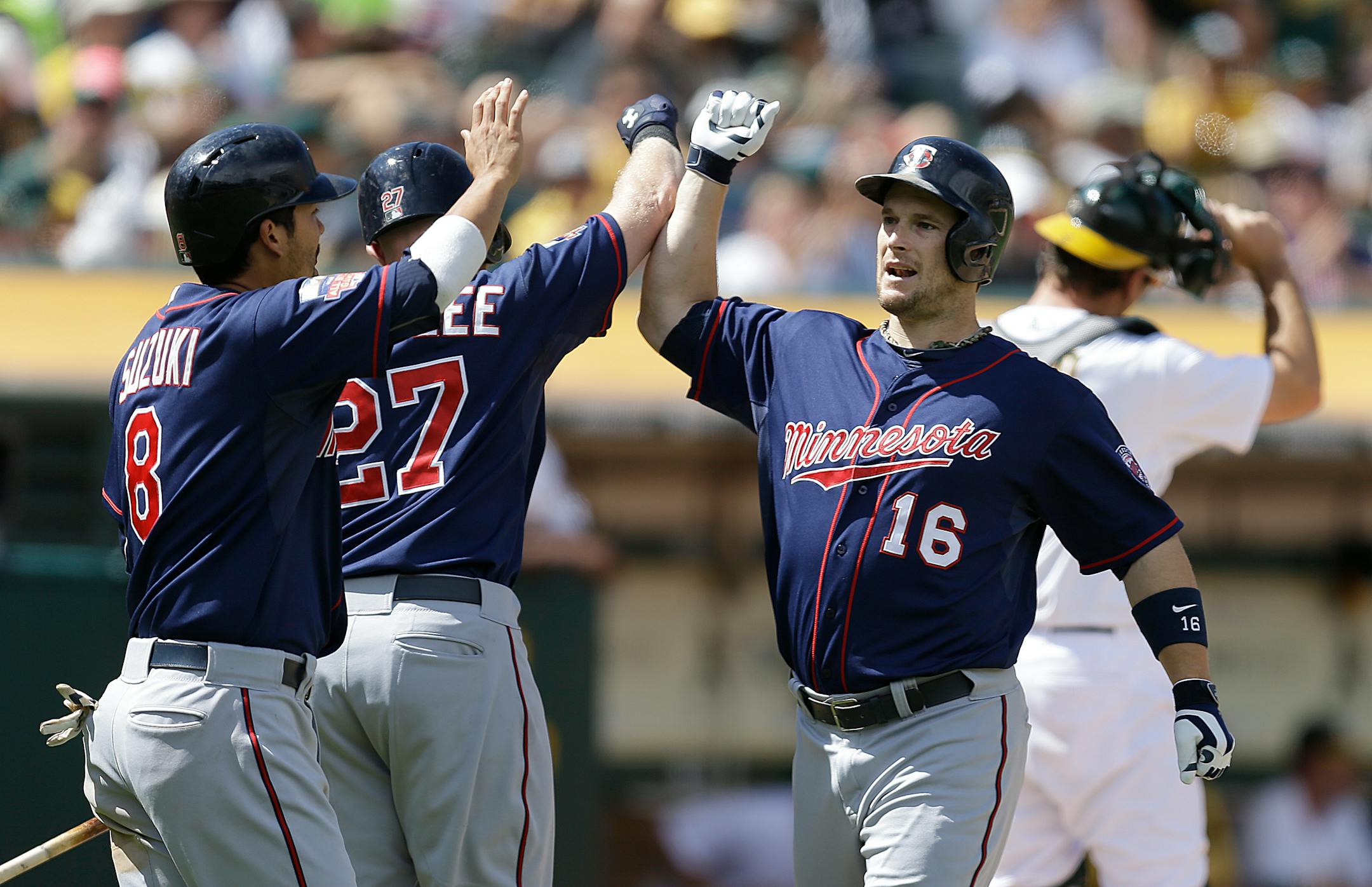 Josh Willingham (16) on Sunday celebrated his two-run homer with teammates Kurt Suzuki, left, and Chris Parmelee. On Monday, Willingham was traded to Kansas City.