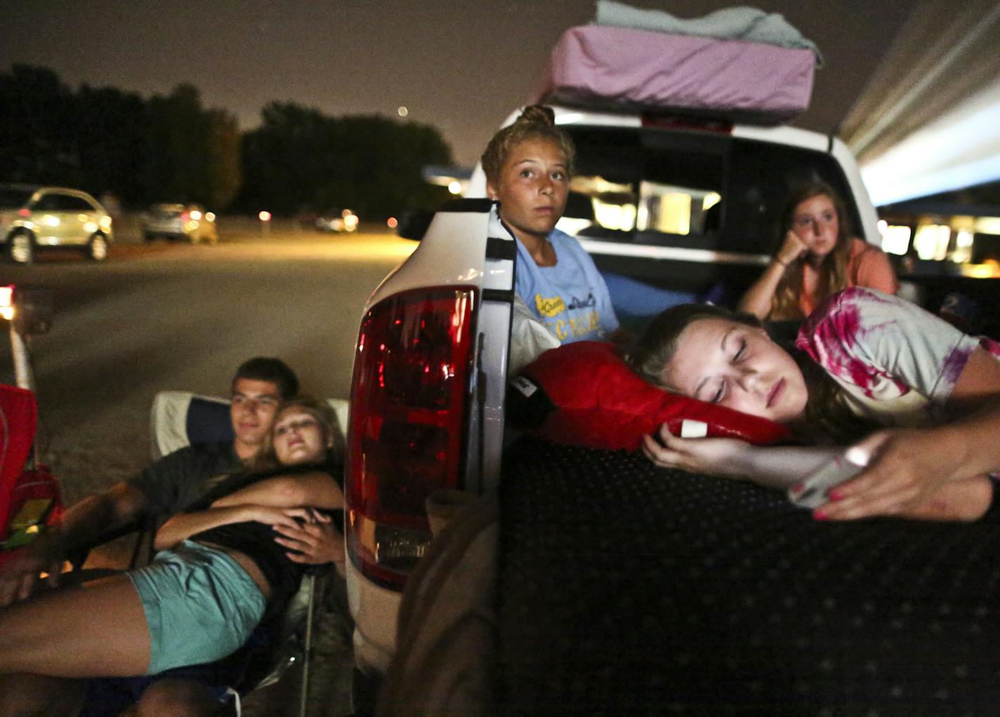 Lauren Mattmiller and Claire Williams (sitting in the left side of the truck), both of Hastings, spent one of their last days of summer watching a movie with friends at Vali-Hi Drive in Lake Elmo, Minn. on Tuesday, August 27, 2013. ] (RENEE JONES SCHNEIDER &#x2022; reneejones@startribune.com)