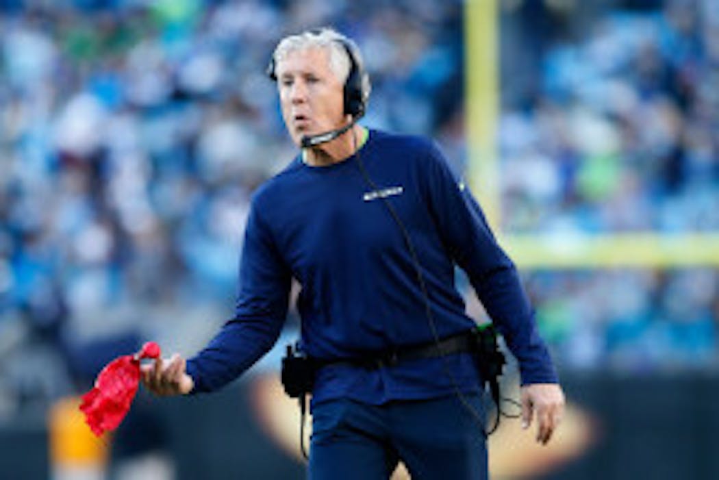 Pete Carroll tosses the red flag to challenge a play during a game last season.