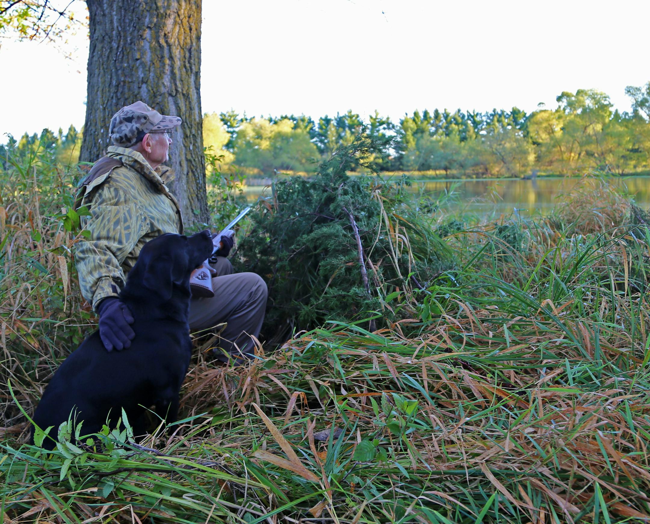 Arnold Krueger and a pal, Jet, looked over a pond on his property about 6 miles from Le Center on Saturday monring, opening day of the Minnesota duck season.