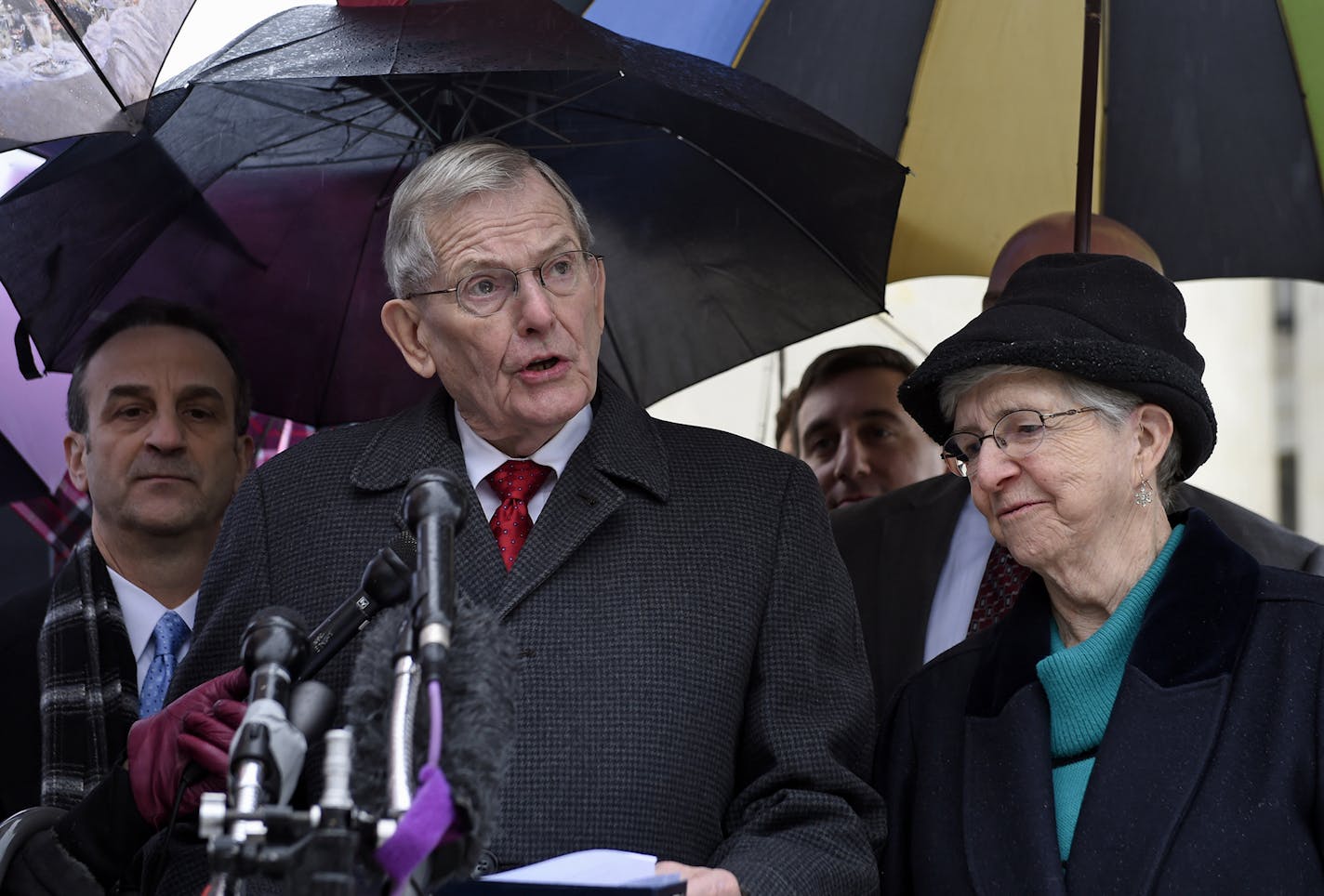 Good News Community Church Pastor Clyde Reed, center, accompanied by his wife Ann, talks to reporters outside the Supreme Court in Washington, Monday, Jan. 12, 2015. The Supreme Court appears likely to side with a small church in its fight with a Phoenix suburb over limits on roadside signs directing people to Sunday services. Liberal and conservative justices expressed misgivings Monday with the Gilbert, Arizona, sign ordinance because it places more restrictions on the churches' temporary sign