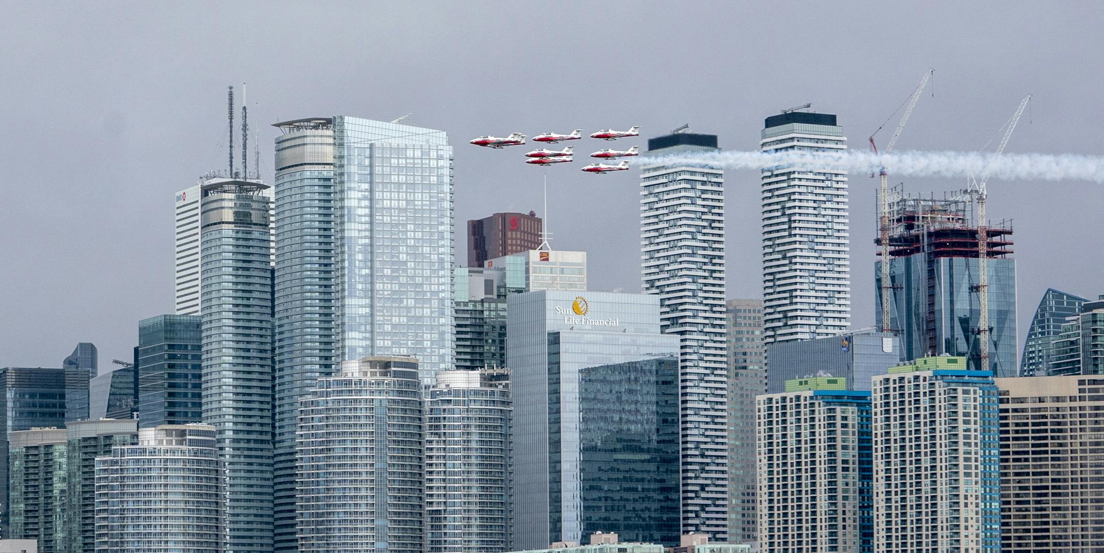 The Canadian Forces Snowbirds fly past the Toronto skyline as part of Operation Inspiration, their cross-country salute to Canadians helping fight the spread of COVID-19, on Sunday, May 10, 2020. (Frank Gunn/The Canadian Press via AP)
