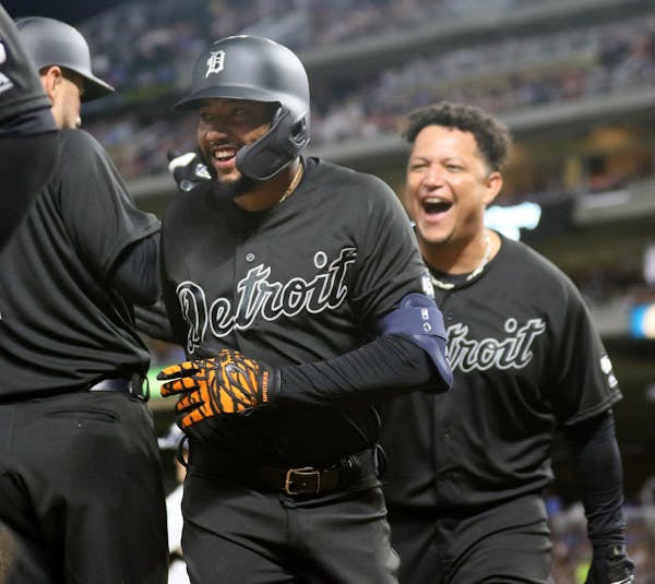 Ronny Rodriguez celebrated his sixth-inning grand slam with teammates including Miguel Cabrera, right.