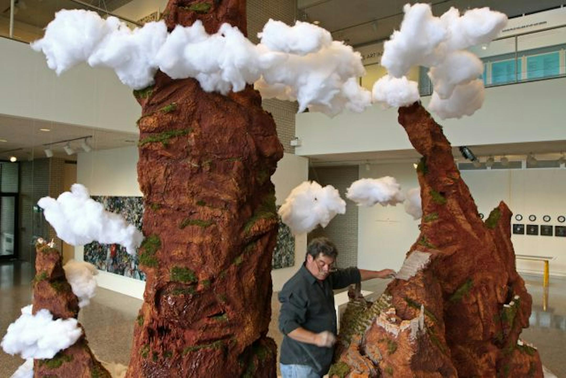 Artist Aldo Moroni worked on his "Fragilearth" sculpture in the MCAD gallery.