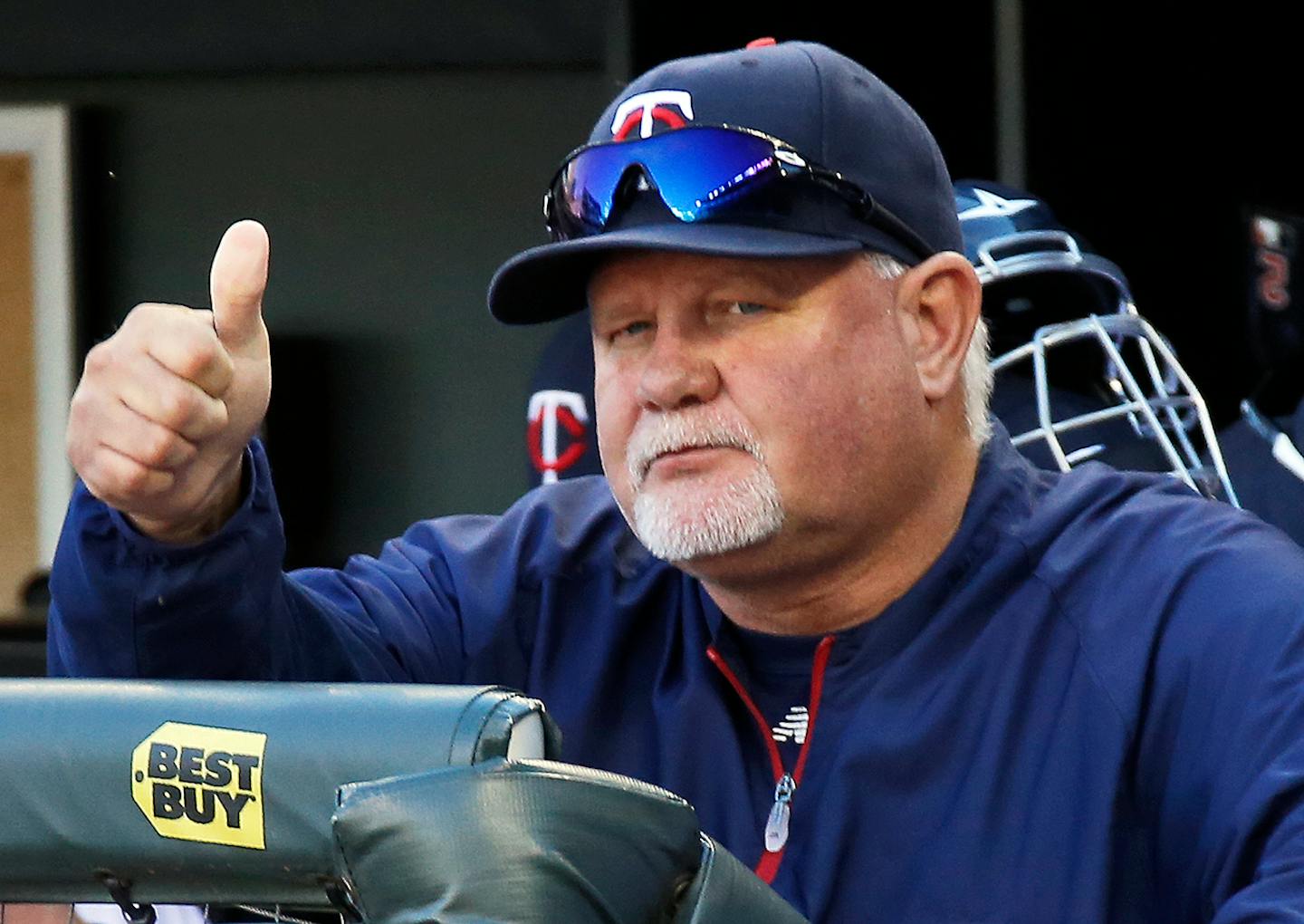 Twins manager Ron Gardenhire signals "good luck" to Cleveland manager Terry Francona.