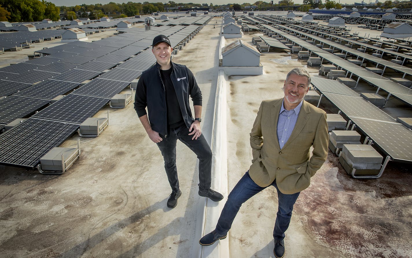 Griffin Dooling of Blue Horizon Energy, left, and founder Christopher Wyffels of Superior Companies, stood on the roof of Superior, a warehouse and logistics firm that is based in St. Paul. Crews from Blue Horizon Energy installed solar-energy arrays on Superior's huge, three-acre flat roof that should save about $90,000 a year on energy costs. PHOTO: Lliz.Flores@startribune.com