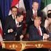 President Donald Trump, center, shakes hands with Canada's Prime Minister Justin Trudeau as Mexico's President Enrique Pena Nieto looks on after they 