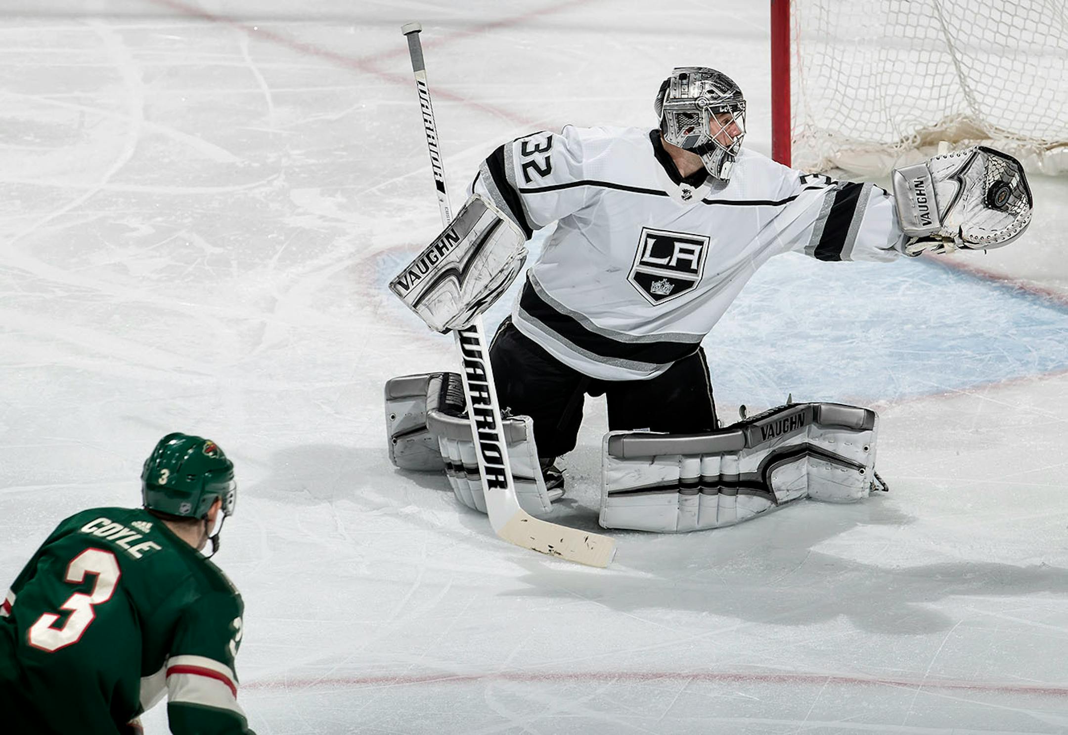 Kings goalie Jonathan Quick (32) made a glove save on a shot by Charlie Coyle (30 in the second period.