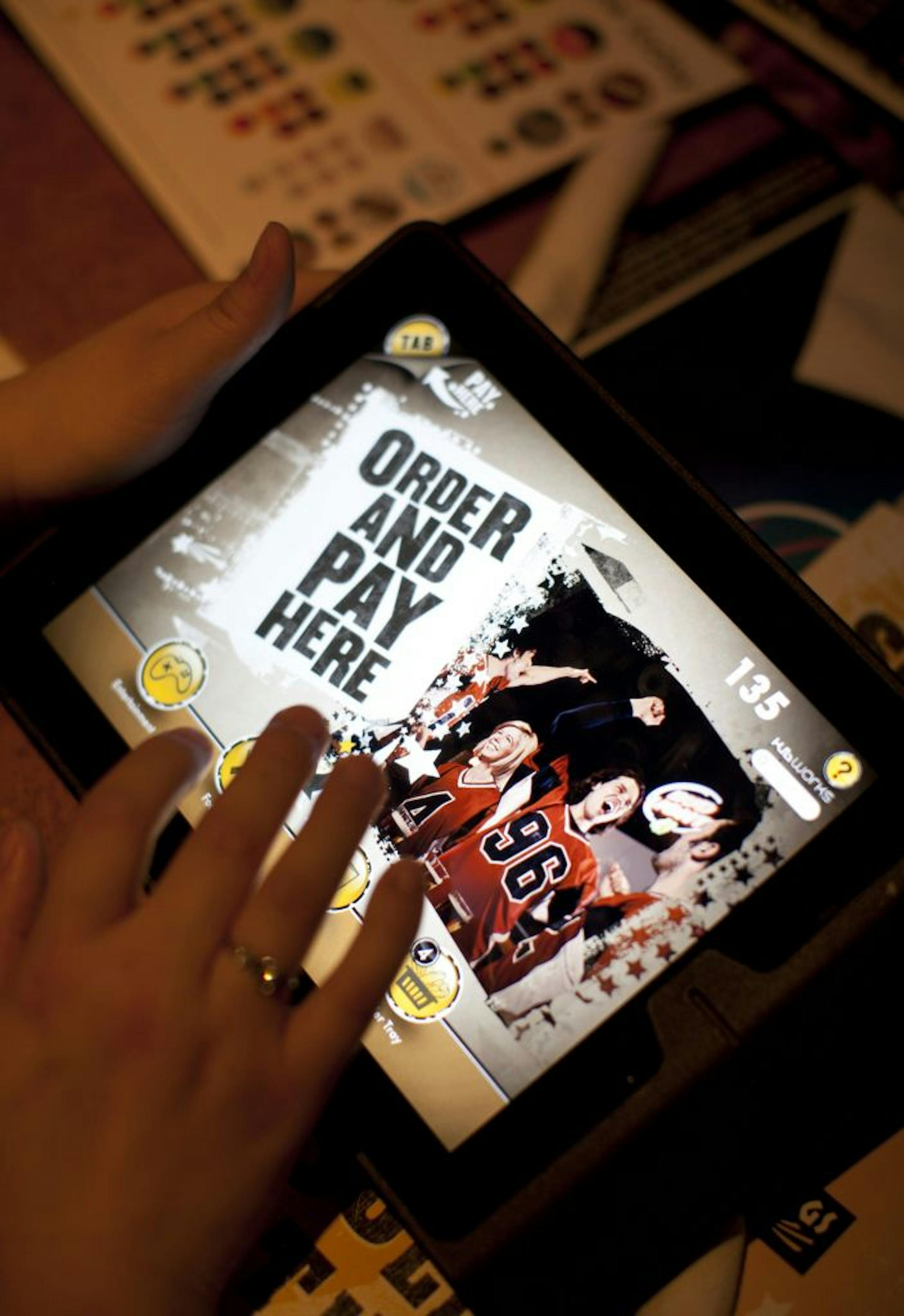 Buffalo Wild Wings is one of the first national restaurant chains to offer Apple iPads at tables so customers can order food, play games and pay their bills electronically if they wish. The concept is being test-marketed at their Oakdale, Minn. restaurant; if it goes well, a national roll-out will follow. Sheng Hang of St. Paul placed the order for her table on an iPad Tuesday night, March 6, 2012 at the Buffalo Wild Wings in Oakdale, Minn.