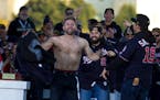 Washington Nationals second baseman Brian Dozier stands shirtless at a rally after a parade to celebrate the team's World Series baseball championship