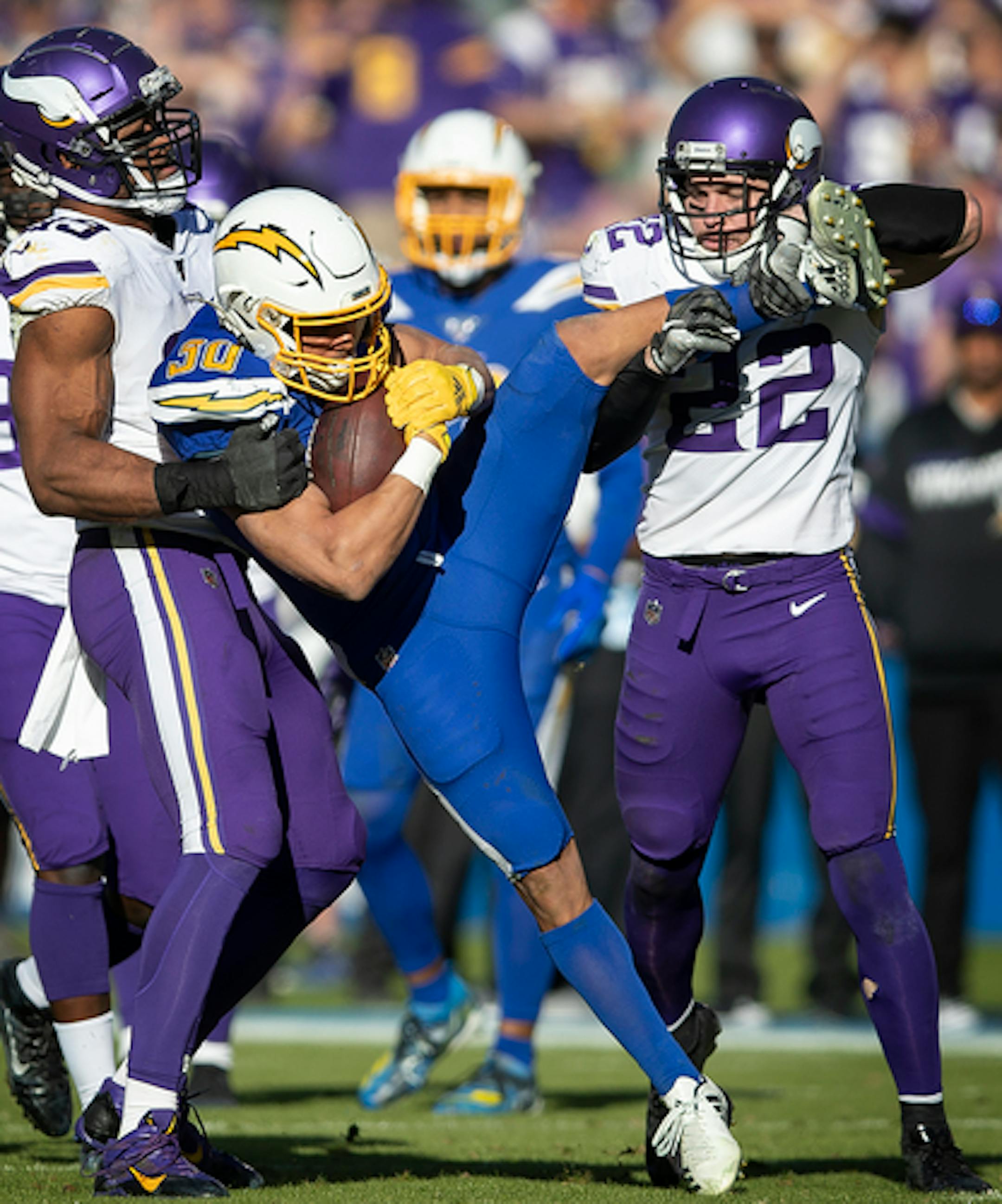 Minnesota Vikings defensive end Danielle Hunter (99) and safety Harrison Smith (22)  tackled Los Angeles Chargers running back Austin Ekeler (30) after a short run in the first quarter.] Jerry Holt • Jerry.Holt@startribune.com