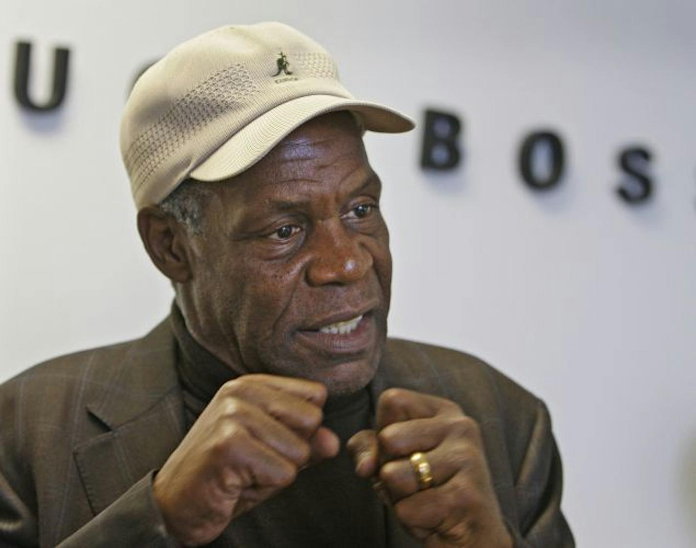 Actor Danny Glover talks to reporters after meeting workers at the Hugo Boss plant in Brooklyn, Ohio, Tuesday, March 23, 2010. Boss is planning on closing the plant and moving the work overseas.