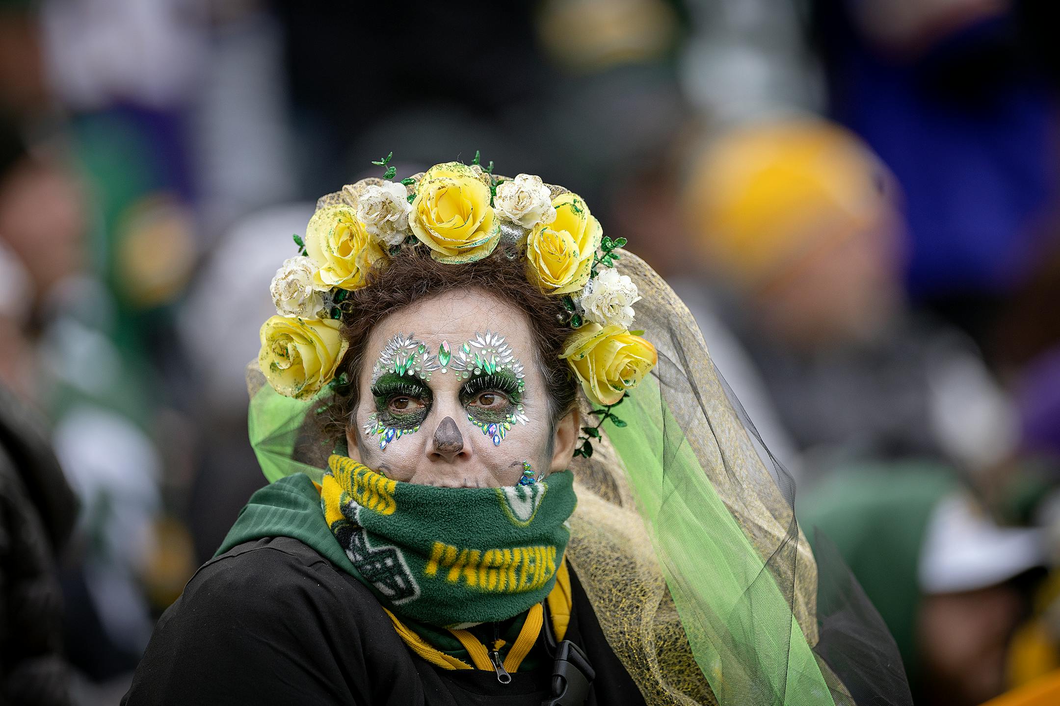 A Packers fan dressed in Dia De Los Muertos makeup — Day of the Dead — looked on.
