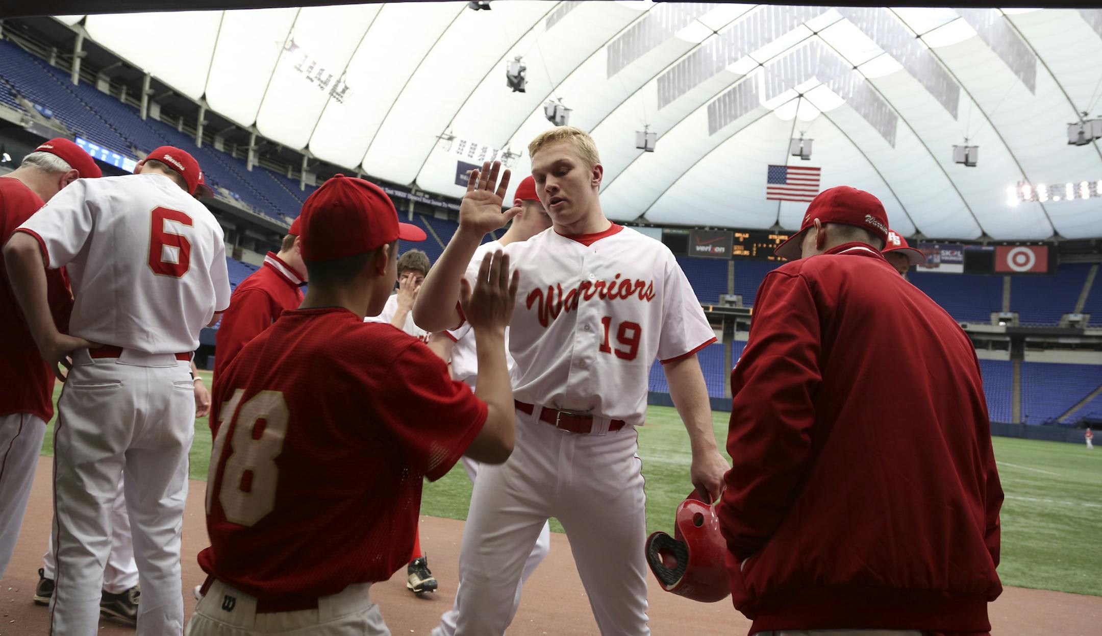Henry Sibley's Jake Ihrke got a hi-five from teammate Issac Morse after Jake scored a run in the first against Highland Park at Mall of America Field in Minneapolis, Min., Tuesday, April 2, 2013. ] (KYNDELL HARKNESS/STAR TRIBUNE) kyndell.harkness@startribune.com