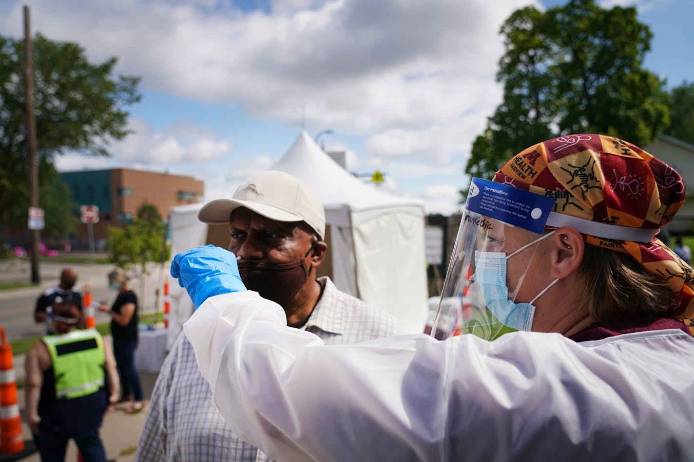 Rachel Miller administered a test to Reverend Alfred Babington-Johnson during a free testing event at New Salem Baptist Church in Minneapolis. Babington-Johnson said it's imperative that people get tested because the African American community is the most vulnerable to the virus.