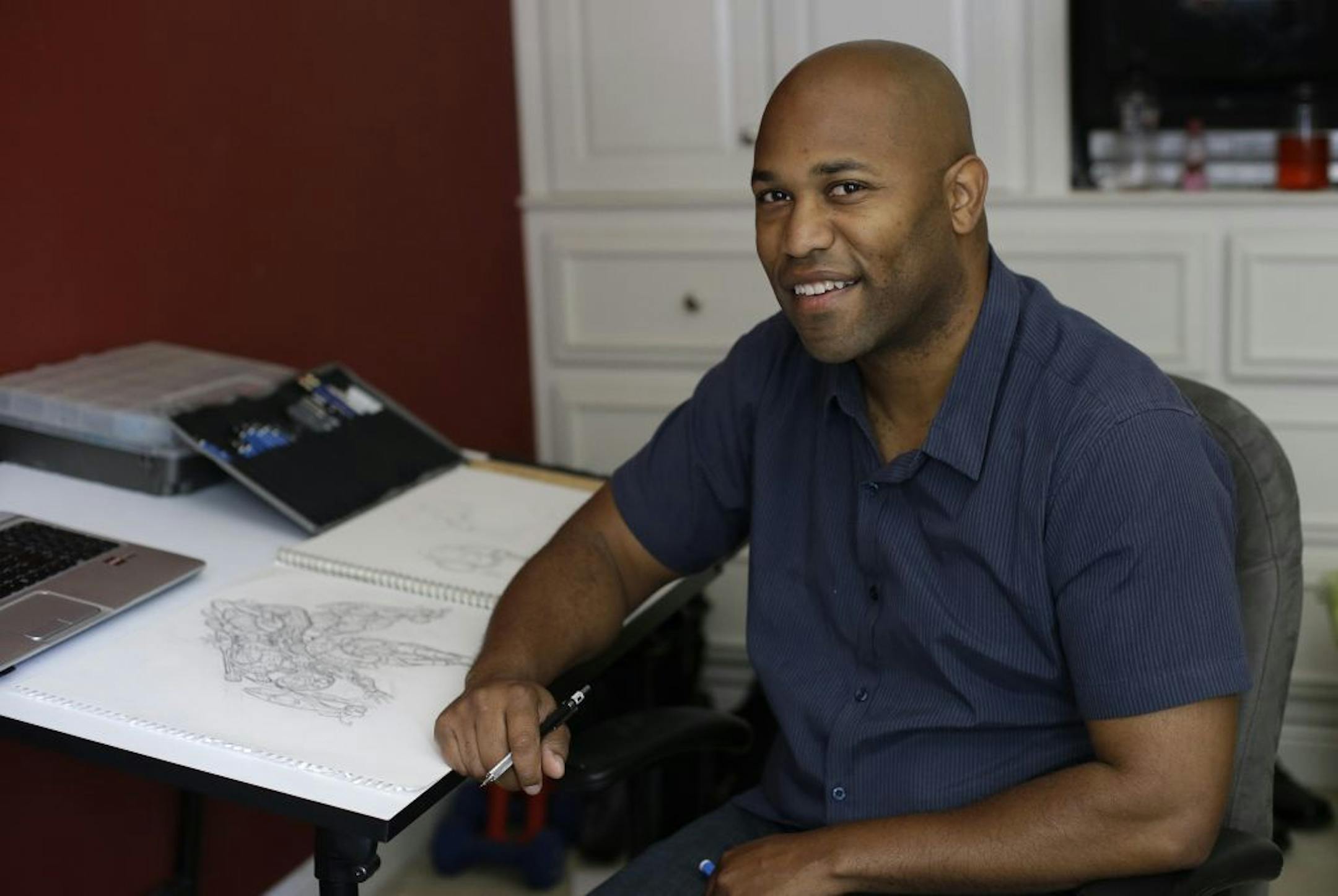 Digital media artist Christopher Jones sits at his desk at his home in Livermore, Calif. on Tuesday, June 4, 2013. After more than seven years and a move 2,800 miles across the country, Jones thought he'd left behind reminders of the arrest that capped a bitter break-up. That was, until he searched the Internet in May 2013 and came face-to-face with his 2006 police mug shot. The information below the photo, one of millions posted on commercial website mugshots.com, did not mention that the apart