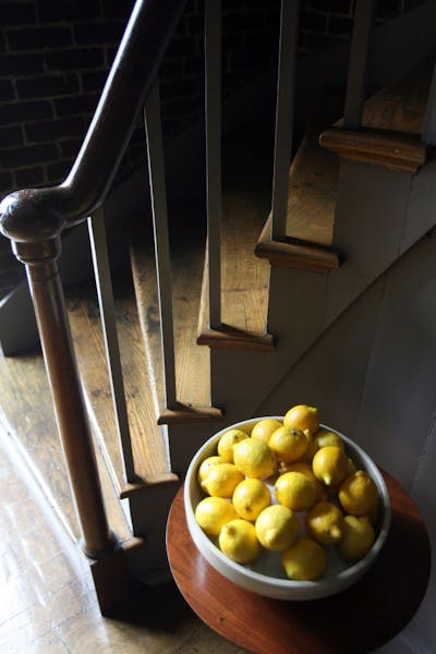 A bowl of lemons (from which well known lemon pie is made) decorates an area near the dining room of the Trustees Office in Shaker Village of Pleasant